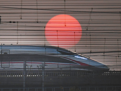 夕阳下，“复兴号”高速列车从武汉动车段旁经过。本报记者 雷 声摄 