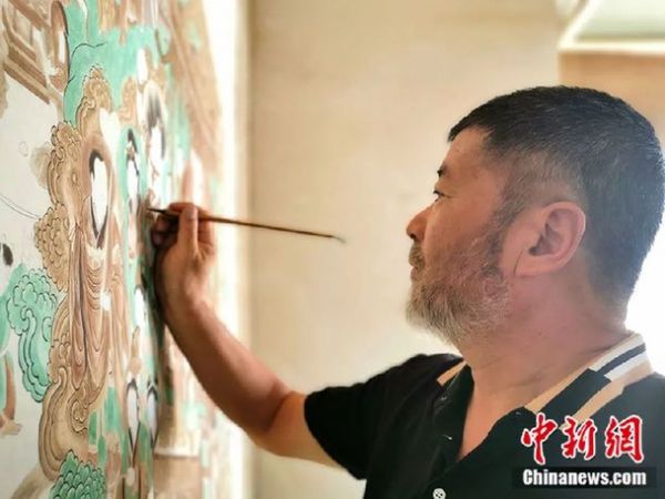 图为从事敦煌壁画临摹工作30多年的牛玉生，已两鬓斑白。(资料图)